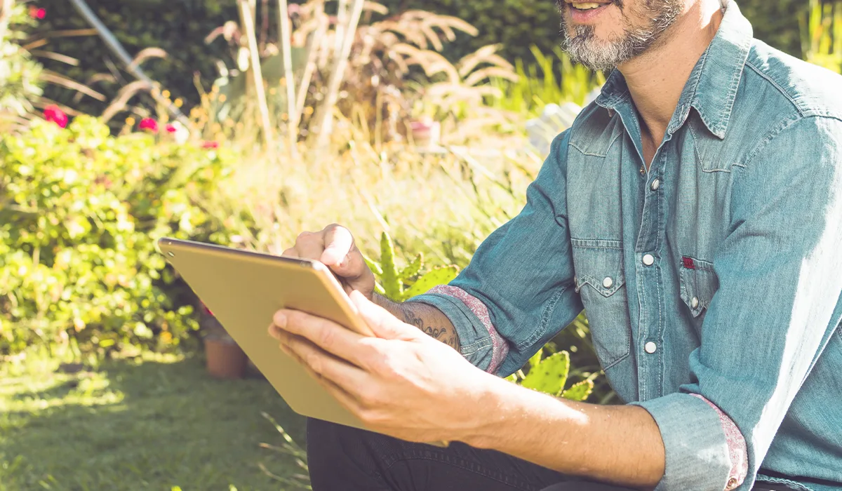 Surveyor assessing a garden with a tablet